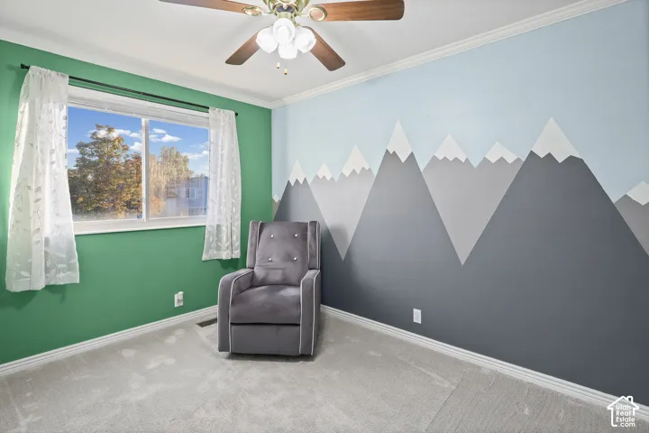 Bedroom with neutral carpeting, crown molding, and a ceiling fan with integrated lighting