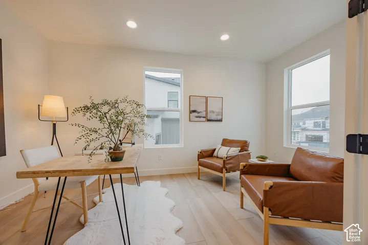 Neutral-toned interior featuring wood-finish flooring, recessed lighting, and double-pane windows
