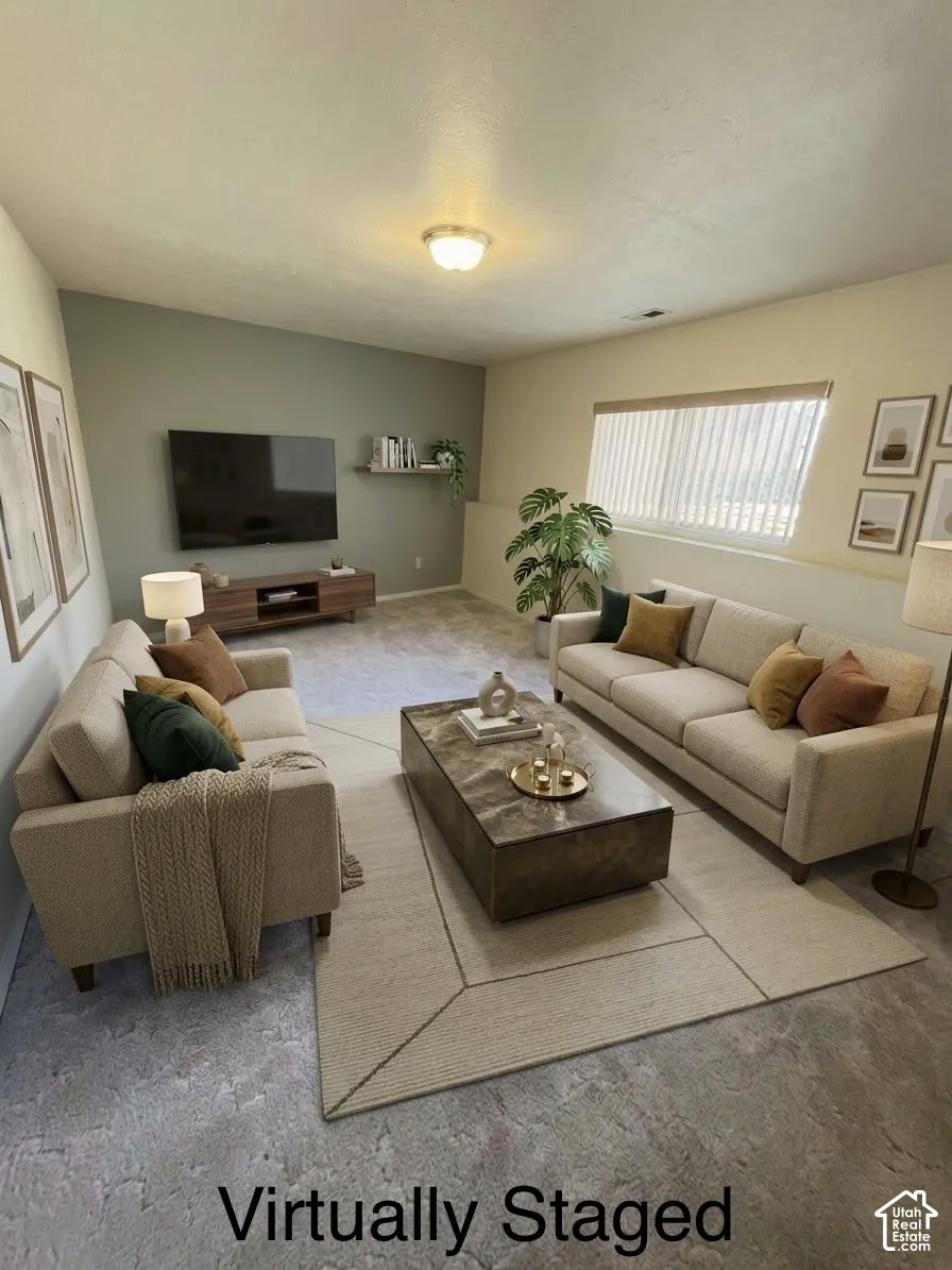 Living area featuring neutral-toned carpeting, a horizontal window with vertical blinds, a singular floating wall shelf, and a flush-mount light fixture