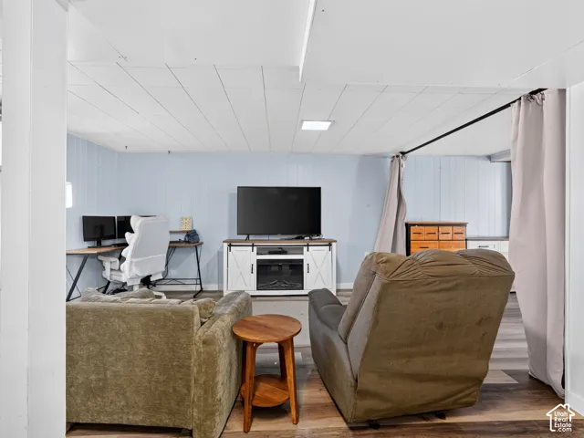 Finished room with wood-finish flooring, plank-style ceiling, and recessed lighting