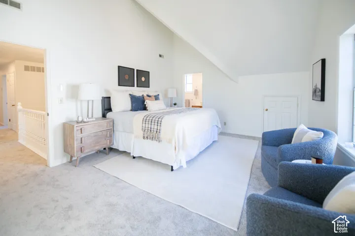Vaulted ceiling, neutral wall tones, carpeted flooring, and built-in knee wall storage