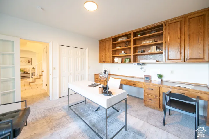 Built-in oak cabinetry with open shelving and lower drawer storage, paired with an integrated wooden desk surface