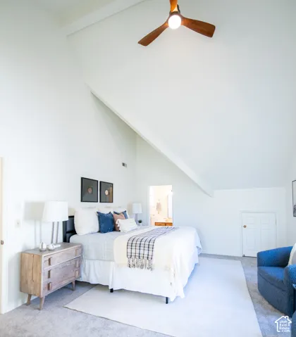 Vaulted ceilings, angular architectural lines, and a three-blade ceiling fan with integrated light fixture