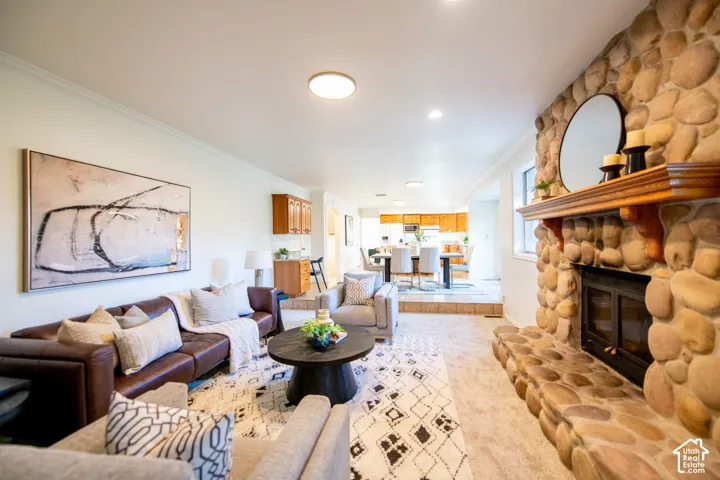 Floor-to-ceiling river rock fireplace with raised hearth and wood mantel