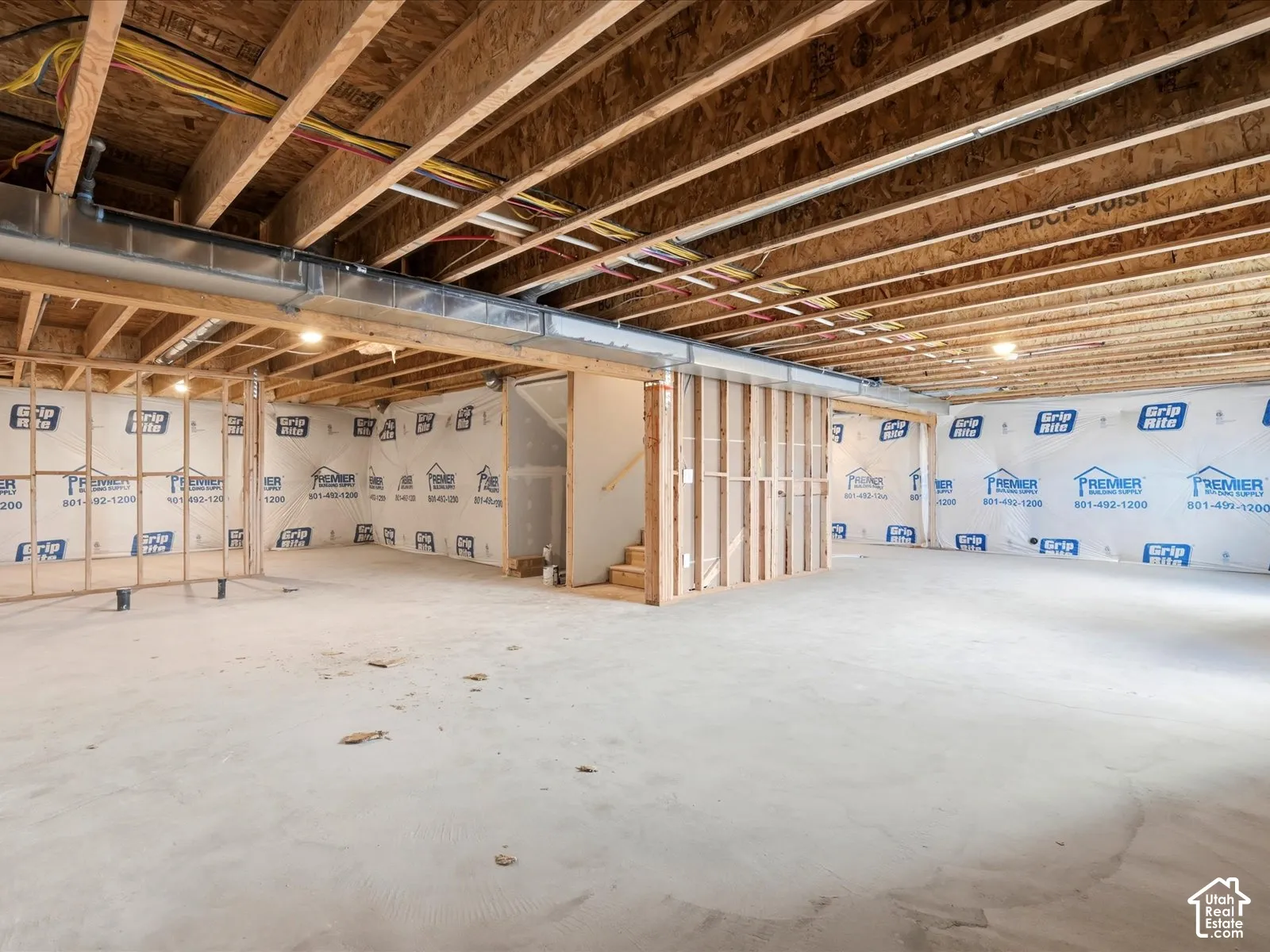 Unfinished lower level featuring exposed wood joist ceilings, concrete flooring, and framed wall partitions