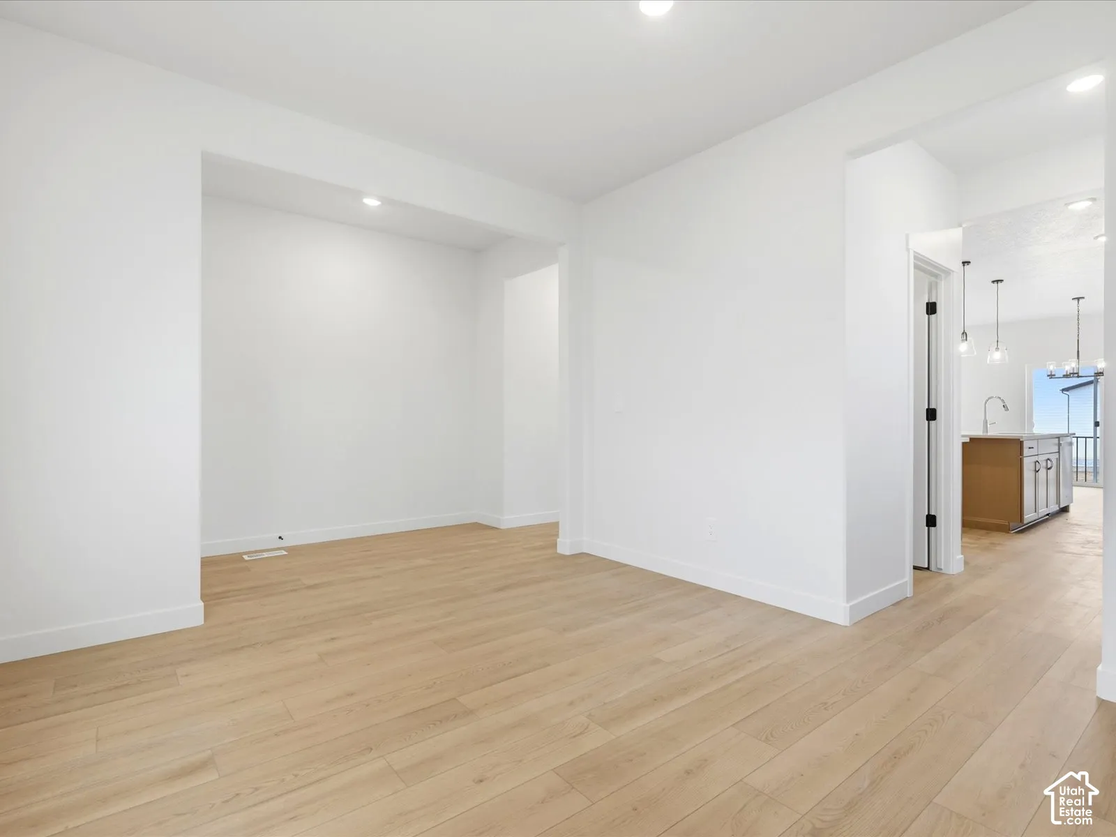 **DISCLAIMER**  Interior package may vary. Neutral interior space featuring light wood-finish flooring, recessed lighting, and clean-lined architecture
