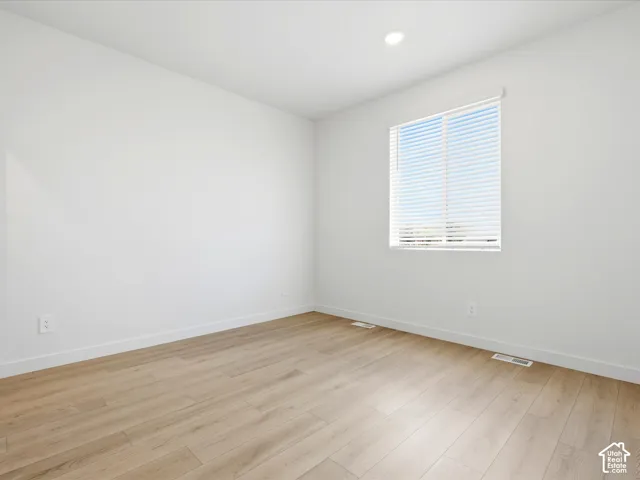 **DISCLAIMER**  Interior package may vary. Neutral-toned room featuring wood-finish flooring, recessed lighting, and a single window with horizontal blinds