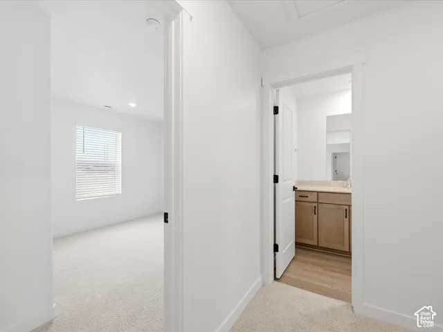 **DISCLAIMER**  Interior package may vary. Neutral-toned carpeting, wood-finish cabinetry, light-toned countertops, white interior doors with black hardware, and crisp white wall finishes