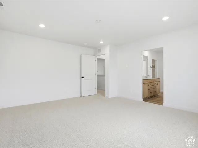 **DISCLAIMER**  Interior package may vary. Neutral-toned carpeted flooring, recessed lighting, and solid-core interior doors with matte black hardware