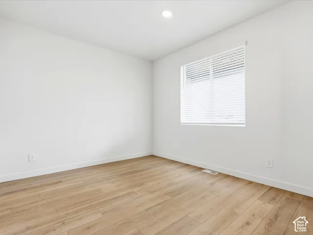 **DISCLAIMER**  Interior package may vary. Neutral-toned room featuring wood-finish flooring, recessed lighting, and a single window with horizontal blinds