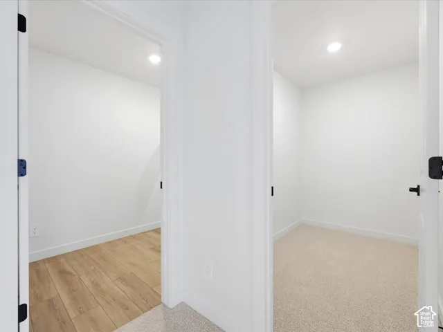 **DISCLAIMER**  Interior package may vary. Interior doorways featuring matte black hardware, recessed ceiling lighting, wood-finish flooring, and wall-to-wall carpeting