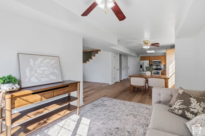 Interior featuring wood-finish flooring, recessed ceiling lighting, dual ceiling fans, and wood-finish cabinetry