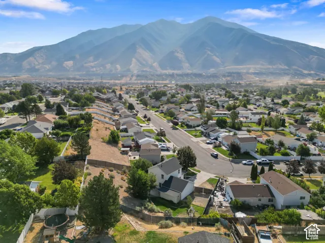 Aerial perspective featuring an expansive mountain backdrop and established residential neighborhood