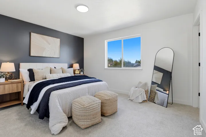 Neutral carpeting, charcoal accent wall, flush-mount ceiling lighting, and a dual-pane sliding window