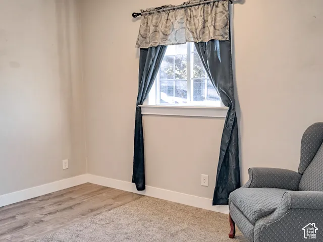 Multi-pane window with a sill and wood-finish flooring