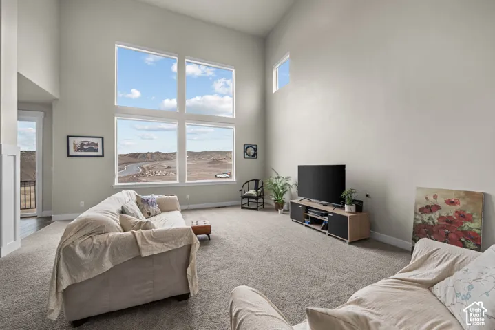 High ceilings featuring expansive multi-pane windows and neutral wall finishes