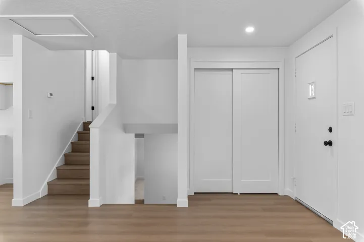Interior Entryway Featuring Coat Closet & Staircase with LVP Finished Stair Treads
