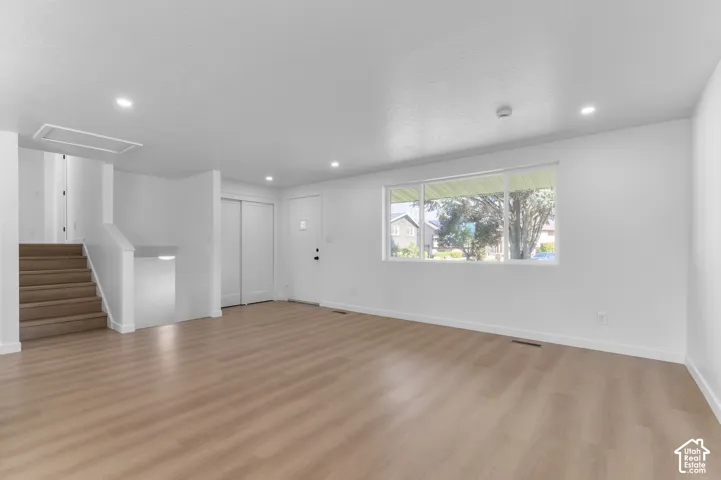 Open-Concept Living Room Featuring NEW LVP Flooring & NEW Large Window