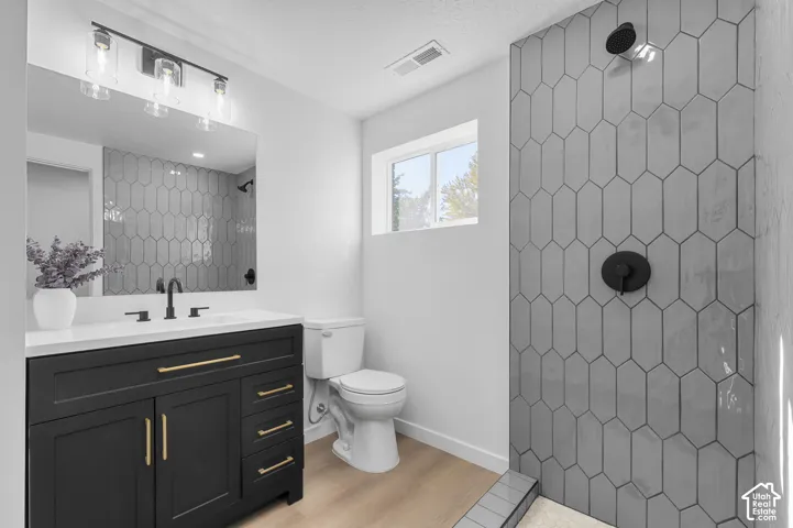 ALL NEW Bathroom Featuring Large Vanity, Marble Countertop, Oversized Vanity Mirror, Waterproof LVP Flooring, Matte Black Fixtures, And Large Walk-In Shower Tiled To The Ceiling