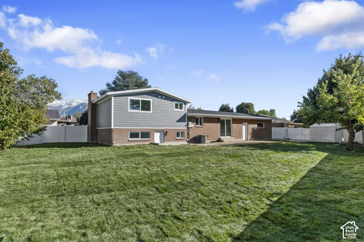 HUGE Expansive Backyard Featuring A Manicured Lawn, Full-Perimeter Fencing, And A Mountain Backdrop