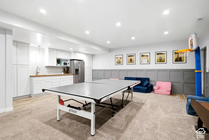Finished room featuring recessed lighting, gray wainscoting, and carpeted flooring
