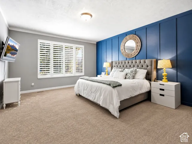 Board and batten accent wall, window with interior shutters, flush-mount ceiling lighting, and wall-to-wall carpeting