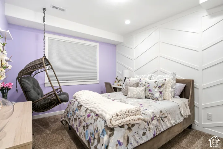 Geometric white board-and-batten accent wall, neutral carpeting, and cellular shades