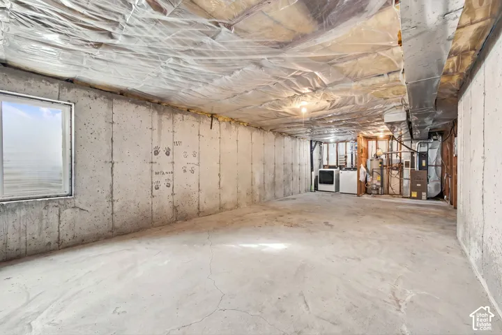 Unfinished utility space featuring concrete foundation walls, concrete flooring, and an egress-style window