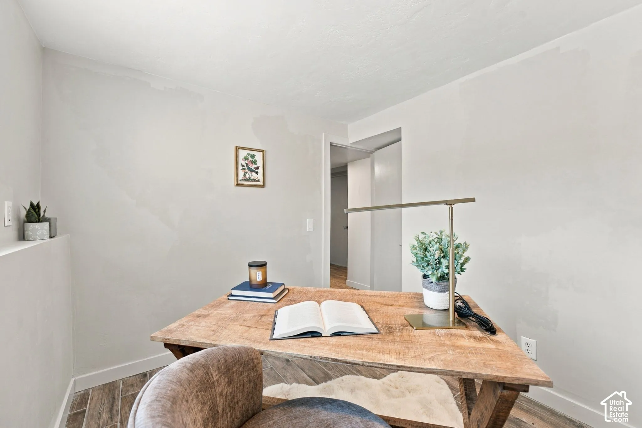 Neutral wall finish featuring tile flooring and a doorway leading to a secondary interior space