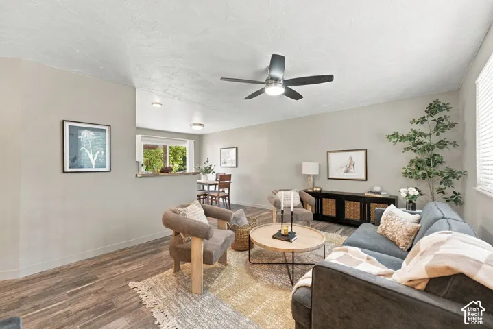 Living area featuring wood-finish flooring, recessed lighting, and a central ceiling fan