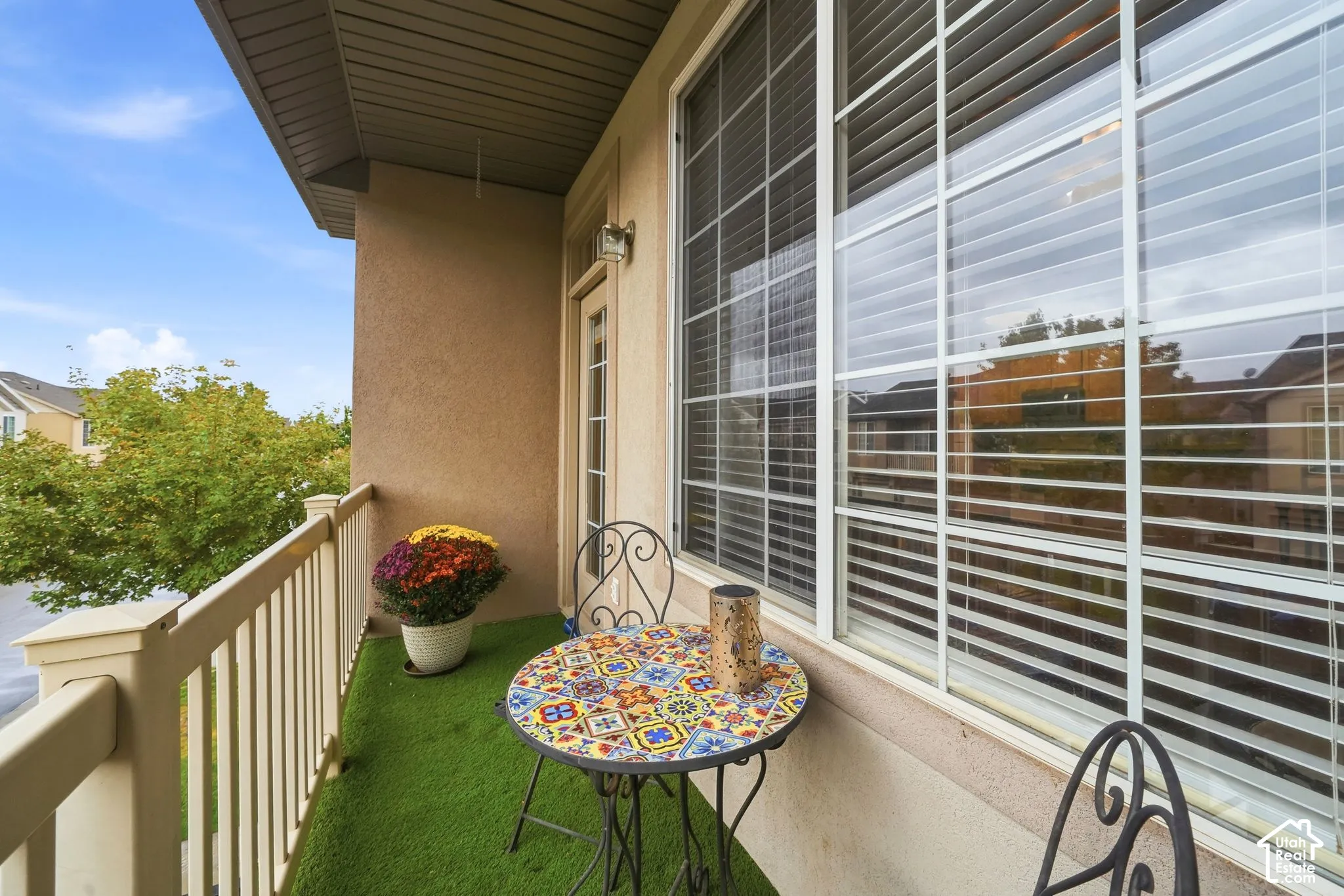 Covered balcony with space for a bistro table.