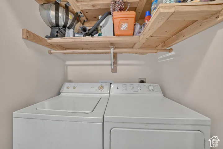 Laundry area with shelving; appliance inclusions require seller confirmation.