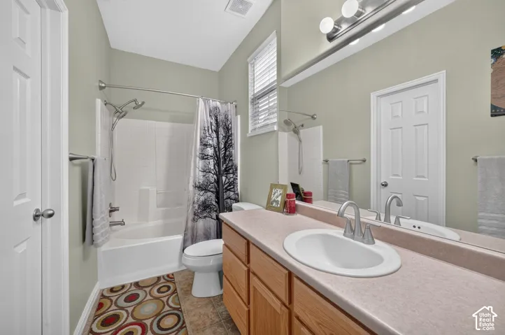 Primary bathroom with vanity and tub/shower combination.