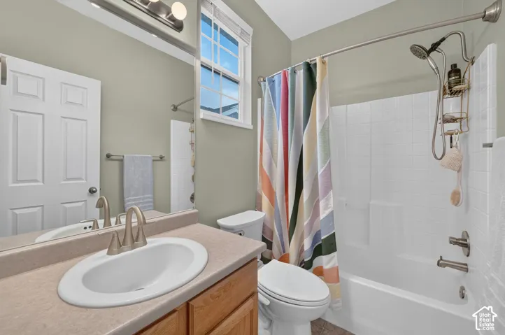 Second bathroom with vanity and tub/shower combination.