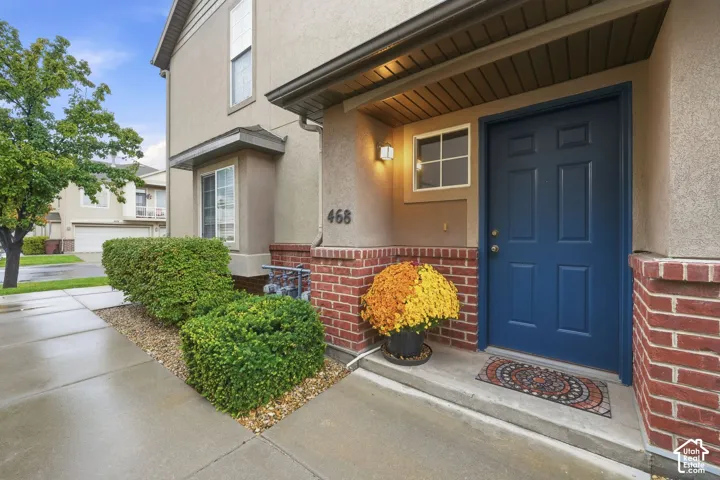 Covered front entry with the number 468 beside the blue door.