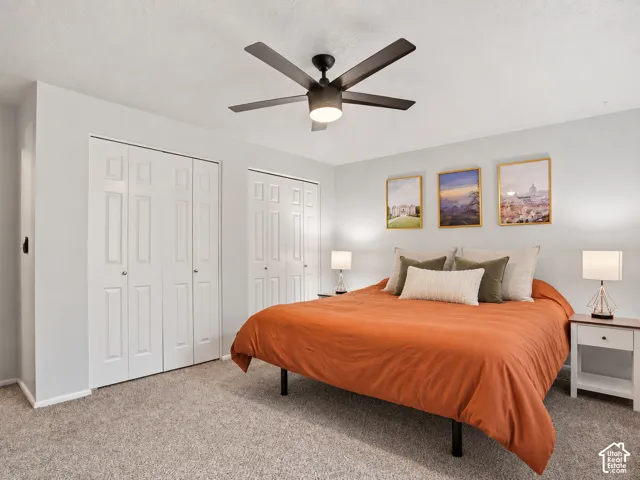 Neutral wall tones featuring dual bi-fold closets and a dark-finish ceiling fan with integrated lighting