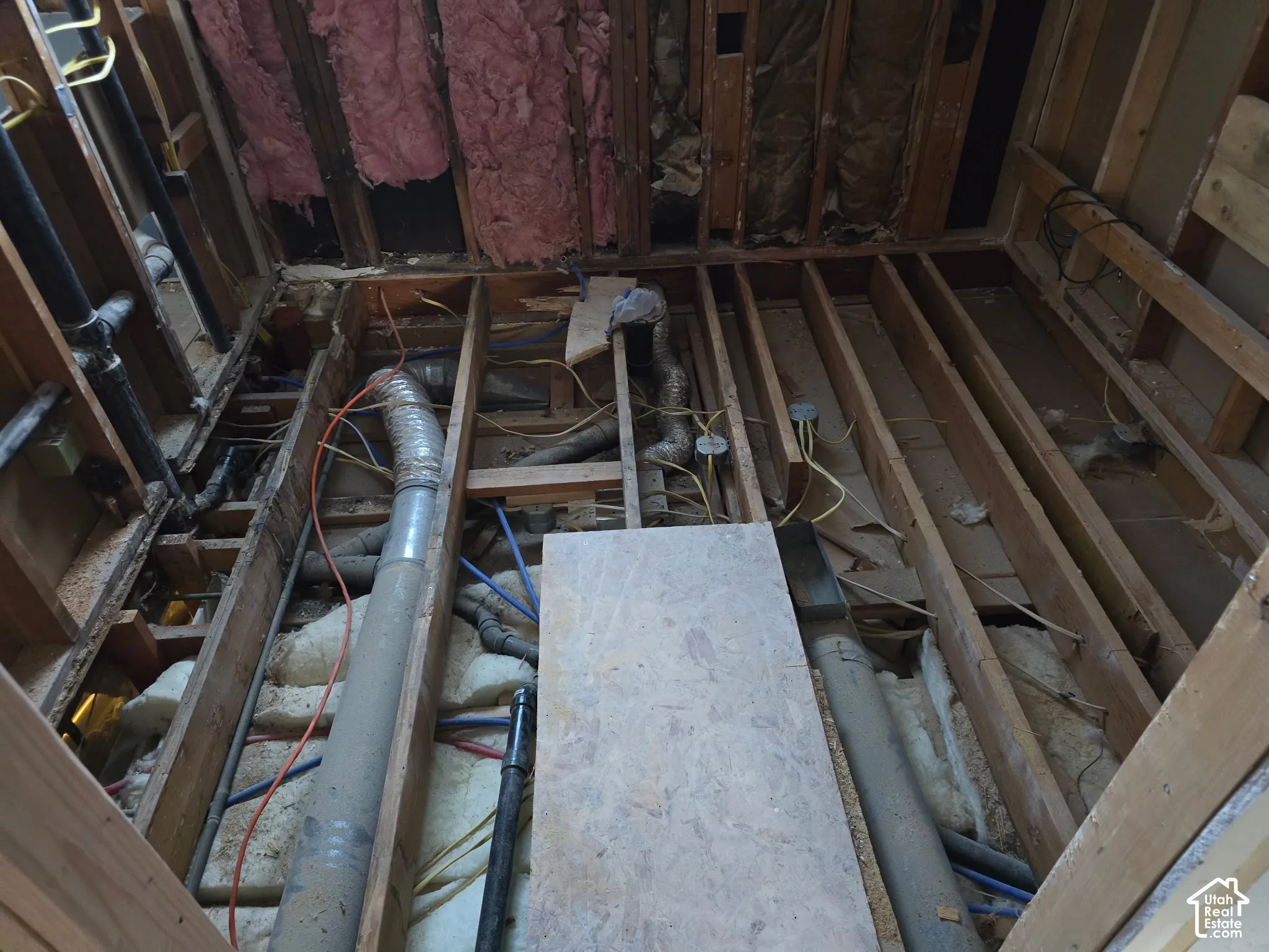 extensive remodel updates.  not a flip. updated electrical and plumbing upstairs. Exposed wood framing, accessible utility infrastructure, visible plumbing lines, ductwork, and wall insulation