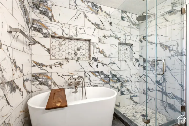 Entire bathroom was taken down to stubs for this remodel.  Soaker tub, separate glass enclosed shower. Porclein tile.