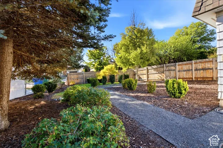 manicured backyard with gravel path, wood fencing, low maintenance yard.