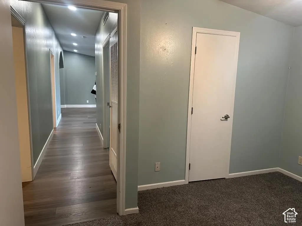 Interior space featuring wood-finish flooring, neutral paint palette, recessed lighting, and textured wall finish