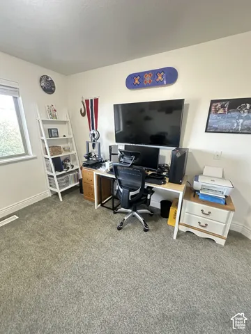 Neutral-toned wall paint, plush carpeting, and a window with white casing