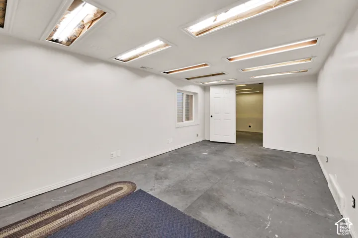 Interior space featuring recessed lighting, a single window, and a six-panel door