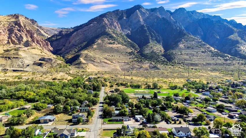 Aerial perspective showcasing proximity to mountain topography, mature trees, and open landscapes