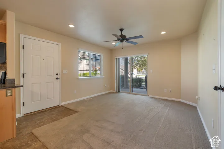 Interior space featuring recessed lighting, a ceiling fan, sliding glass doors, and window blinds