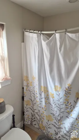 Curved shower curtain rod and window with decorative sill trim