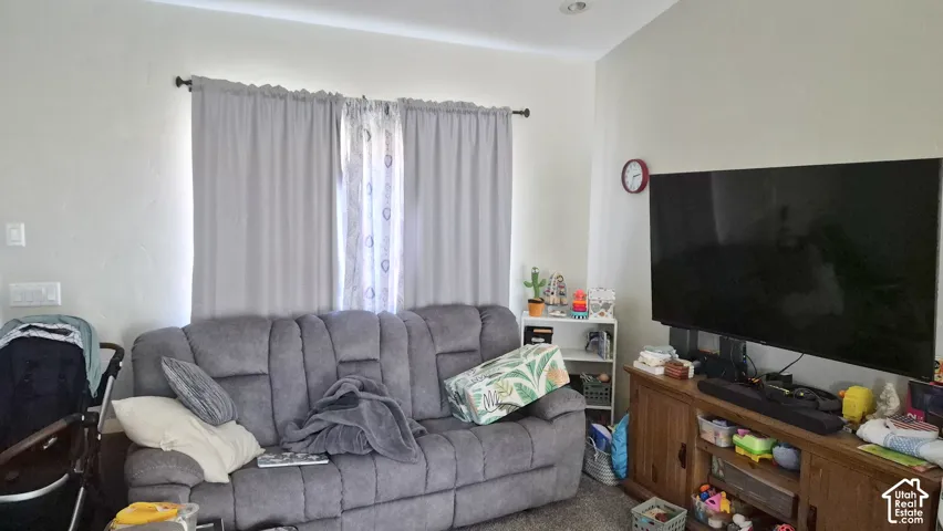 Room with vaulted ceiling, recessed lighting, and wall-to-wall carpeting