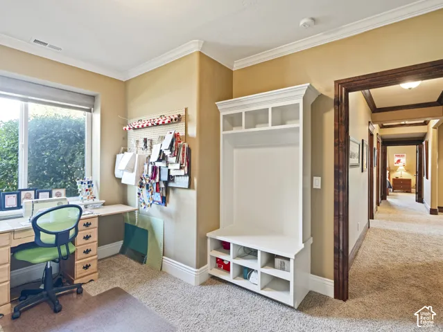 Built-in white storage bench with upper cabinetry, large picture window, and detailed dark wood door casing