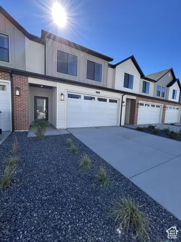 Multi-level exterior featuring a brick and horizontal siding fa