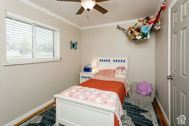 Neutral-toned room featuring a ceiling fan with integrated light fixture, horizontal window blinds, and a paneled interior door