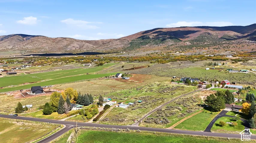Expansive acreage featuring native high-desert vegetation, mature evergreen trees, open terrain, and mountain backdrops